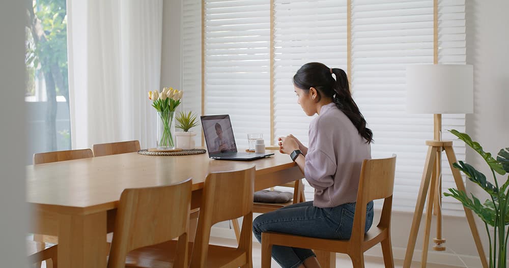 Obesity and Cancer Risk — woman discussing preventive health in a telemedicine visit from home.
